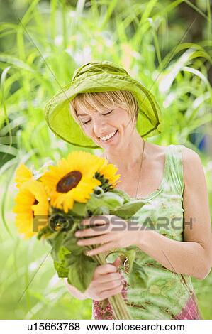 portrait of a woman with sunflowers View Large Photo Image Stock Photo - portrait of a woman with sunflowers. Fotosearch
