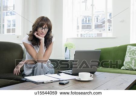 Stock Photo - Portrait of Business women on sofa. Fotosearch