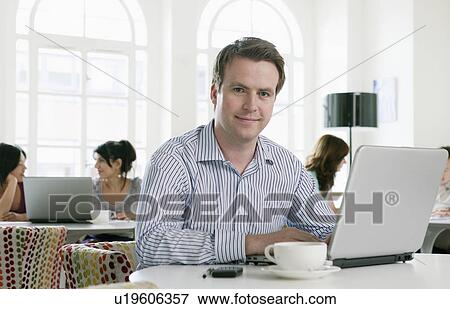 Stock Photo - Portrait of male with laptop. Fotosearch