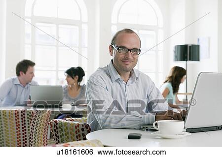 Portrait of man with laptop View Large Photo Image Stock Photograph - Portrait of man with laptop. Fotosearch