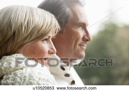 Stock Image - Portrait of middle aged couple outdoors. Fotosearch