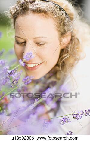 Stock Photography - portrait of middle-aged woman and flower. Fotosearch