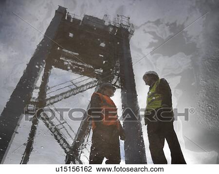 Stock Image - Reflection Of Container Port Workers. Fotosearch
