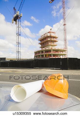 Safety hat & Plans Outside Building Site View Large Photo Image Stock Photography - Safety hat & Plans Outside Building Site. Fotosearch