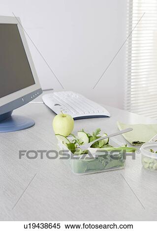 Stock Photography - salad on desk in office. Fotosearch