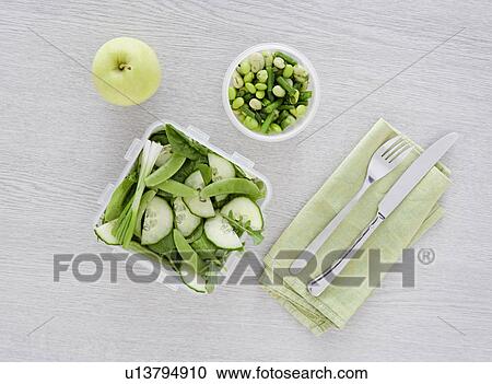 Stock Image - salad on desk. Fotosearch