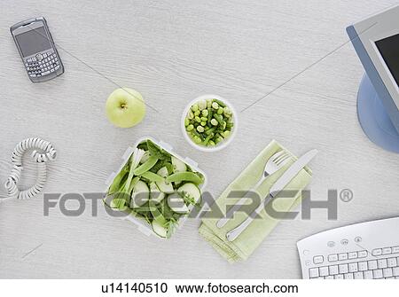 Stock Image - salad on desk. Fotosearch
