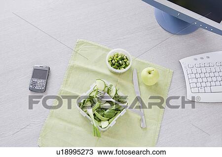 Stock Image - salad on desk. Fotosearch