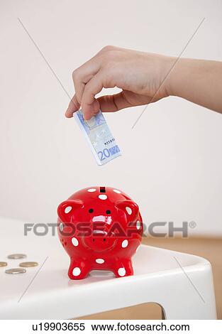 saving money in piggy bank View Large Photo Image Stock Photography - saving money in piggy bank. Fotosearch