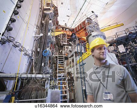 Picture - Scientist In Front Of Fusion Reactor. Fotosearch