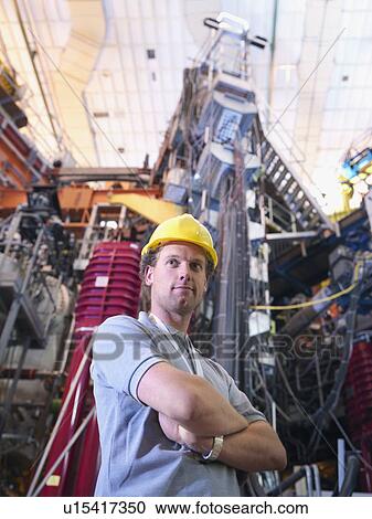 Stock Image - Scientist In Front Of Fusion Reactor. Fotosearch