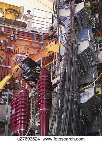 Scientist On Top Of Fusion Reactor View Large Photo Image Picture - Scientist On Top Of Fusion Reactor. Fotosearch