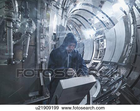 Stock Photo - Scientist Working In A Fusion Reactor. Fotosearch