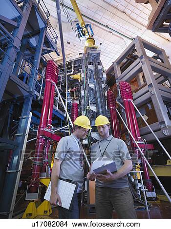Picture - Scientists In Front Of Fusion Reactor. Fotosearch