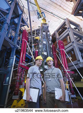 Picture - Scientists In Front Of Fusion Reactor. Fotosearch