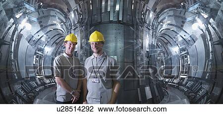 Stock Image - Scientists Inside A Fusion Reactor. Fotosearch