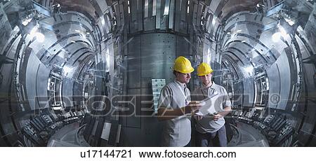 Stock Image - Scientists Working In A Fusion Reactor. Fotosearch