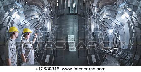 Stock Photograph - Scientists Working In A Fusion Reactor. Fotosearch