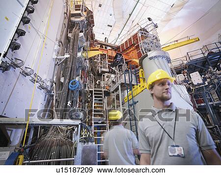 Stock Photo - Scientists Working With Fusion Reactor. Fotosearch