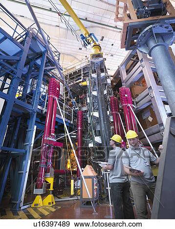 Stock Photo - Scientists Working With Fusion Reactor. Fotosearch