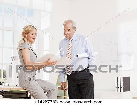 Stock Image - Senior businessman and business woman. Fotosearch