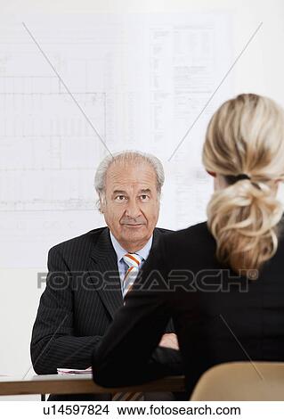 Senior businessman talking to a woman View Large Photo Image Picture - Senior businessman talking to a woman. Fotosearch