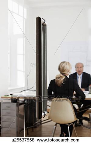 Senior businessman talking to a woman View Large Photo Image Stock Photo - Senior businessman talking to a woman. Fotosearch
