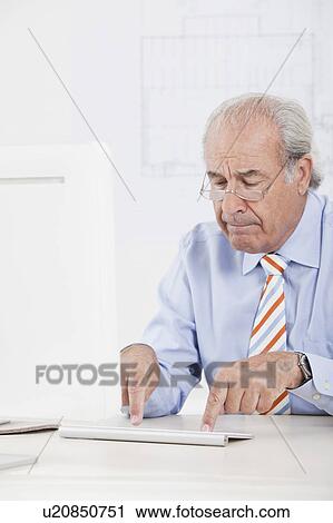 Senior businessman typing clumsily View Large Photo Image Stock Image - Senior businessman typing clumsily. Fotosearch