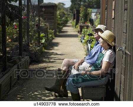 Senior couple resting in an allotment View Large Photo Image Stock Photo - Senior couple resting in an allotment. Fotosearch