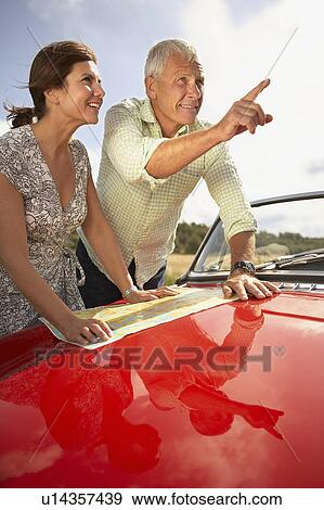 Stock Photo - senior couple with car and map. Fotosearch