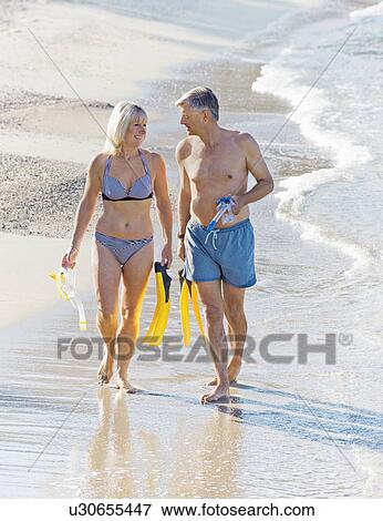 Stock Photo - Senior couple with snorkels and flippers. Fotosearch