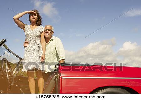 Senior couple with sports car, observing View Large Photo Image Stock Photography - Senior couple with sports car, observing. Fotosearch