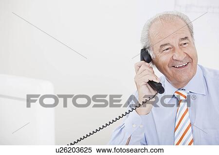 Senior executive on the phone View Large Photo Image Stock Photography - Senior executive on the phone. Fotosearch