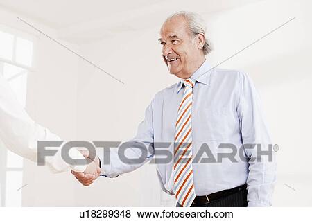 Senior executive shaking hands View Large Photo Image Stock Photo - Senior executive shaking hands. Fotosearch