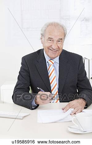 Senior executive signing document View Large Photo Image Stock Photograph - Senior executive signing document. Fotosearch