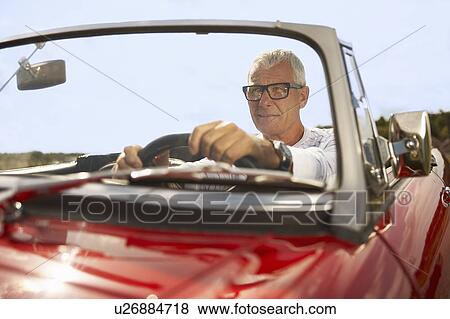 Stock Photo - Senior man in sports car. Fotosearch