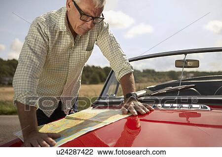 Stock Image - senior man with car and map. Fotosearch