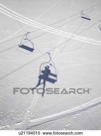 Shadows of people on ski lifts View Large Photo Image Stock Photography - Shadows of people on ski lifts. Fotosearch