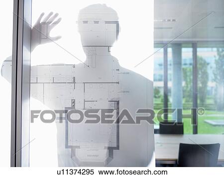 Stock Photography - Silhouette of a man, blue prints in front. Fotosearch