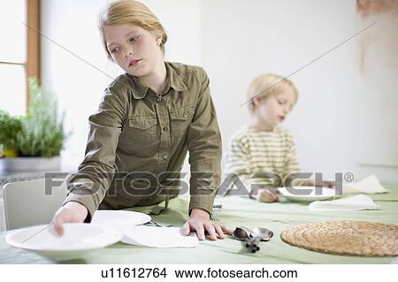 Picture - sister and brother in kitchen. Fotosearch