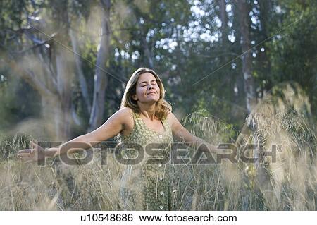 Smiling woman with arms outstretched View Large Photo Image Stock Photograph - Smiling woman with arms outstretched. Fotosearch