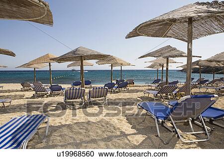 Stock Image - Sunbeds on sandy beach. Fotosearch