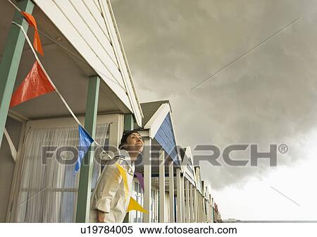 Taking shelter under Beach hut View Large Photo Image Stock Photography - Taking shelter under Beach hut. Fotosearch