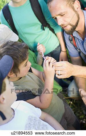 Stock Image - teacher and pupils at the wood. Fotosearch