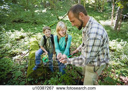 Stock Photo - teacher and pupils at the wood. Fotosearch
