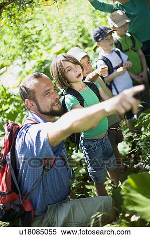 Stock Photography - teacher and pupils at the wood. Fotosearch