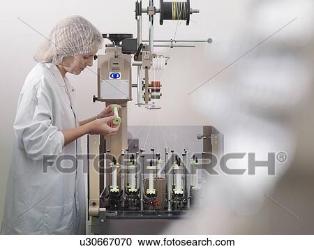 Stock Image - Technician Weaving Medical Product. Fotosearch