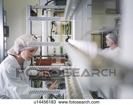 Stock Image - Technicians Weaving Medical Product. Fotosearch