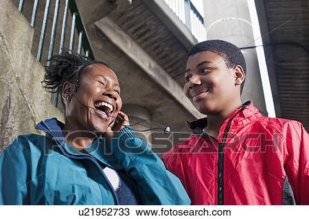 Teenage Boy with mother on headphones View Large Photo Image Stock Image - Teenage Boy with mother on headphones. Fotosearch
