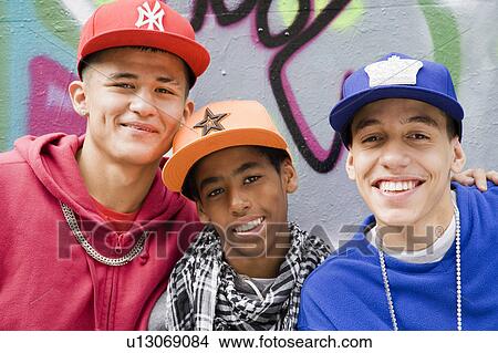 Picture - Teenage gang against graffiti wall. Fotosearch